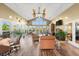 Bright living room featuring high ceilings, ceiling fans, many windows, and comfortable furniture at 1401 S Palmetto Ave # 614, Daytona Beach, FL 32114