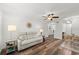 Bright open-concept living space with sleek floors, couch, and dining table with chairs at 1401 S Palmetto Ave # 614, Daytona Beach, FL 32114
