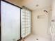 Bathroom with a walk-in shower and glass block feature wall at 1412 Oak Forest Dr, Ormond Beach, FL 32174