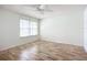Bright bedroom with wood-look floors and ceiling fan at 1412 Oak Forest Dr, Ormond Beach, FL 32174