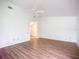 Bright bedroom with ceiling fan and laminate wood flooring at 1412 Oak Forest Dr, Ormond Beach, FL 32174