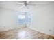 Spacious bedroom with wood-look floors and corner windows at 1412 Oak Forest Dr, Ormond Beach, FL 32174