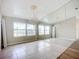 Bright dining room with large windows, chandelier, and tile floors at 1412 Oak Forest Dr, Ormond Beach, FL 32174