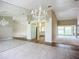 Spacious dining room with a chandelier, mirrored wall, and tile floor at 1412 Oak Forest Dr, Ormond Beach, FL 32174