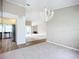 Dining room with chandelier and view into kitchen and living areas at 1412 Oak Forest Dr, Ormond Beach, FL 32174