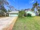 Ranch-style home with attached garage and landscaping at 1412 Oak Forest Dr, Ormond Beach, FL 32174