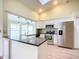 Modern kitchen with white cabinets, stainless steel appliances, and granite countertops at 1412 Oak Forest Dr, Ormond Beach, FL 32174