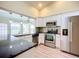 Modern kitchen with white cabinets, stainless steel appliances, and granite countertops at 1412 Oak Forest Dr, Ormond Beach, FL 32174