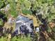 House with a large backyard surrounded by trees at 1450 Alden St, Deland, FL 32720