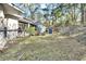 Side yard with chain link fence and wooded area at 1450 Alden St, Deland, FL 32720
