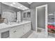 Double vanity bathroom with a large mirror and white cabinets at 1450 Alden St, Deland, FL 32720