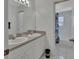 Bathroom with double sinks, white cabinets, and a shower at 1450 Alden St, Deland, FL 32720