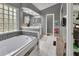 Relaxing bathroom with soaking tub, tiled floor, and walk-in shower at 1450 Alden St, Deland, FL 32720