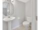 Small half bathroom with pedestal sink and toilet at 1450 Alden St, Deland, FL 32720