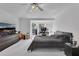 Spacious bedroom with large window, ceiling fan, and mirrored closet doors at 1450 Alden St, Deland, FL 32720