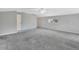 Spacious bedroom with grey carpet, ceiling fan and window at 1450 Alden St, Deland, FL 32720