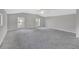 Spacious bedroom with grey carpet, ceiling fan and two windows at 1450 Alden St, Deland, FL 32720