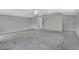 Large bedroom with grey carpet, ceiling fan and en-suite bathroom at 1450 Alden St, Deland, FL 32720