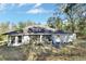 White house back with screened porch and fenced yard at 1450 Alden St, Deland, FL 32720