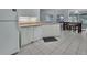 Kitchen with white cabinets, tile floor, and view into adjacent dining area at 1450 Alden St, Deland, FL 32720