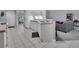 Kitchen features white cabinets, tile floors, and a view into the living room at 1450 Alden St, Deland, FL 32720