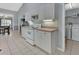 White kitchen cabinets, tile floors, and a view of the laundry area at 1450 Alden St, Deland, FL 32720