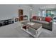 Open living room with a grey sofa, coffee table, and built-in electric fireplace at 1450 Alden St, Deland, FL 32720