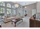 Spacious living room with neutral colors, hardwood floors, and a large window at 1450 Alden St, Deland, FL 32720