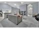 Living room with grey walls, a comfortable sofa, and views into the kitchen at 1450 Alden St, Deland, FL 32720