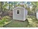 Gray storage shed with a single window at 1450 Alden St, Deland, FL 32720