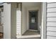 Gray front door with glass accents, located under a covered porch at 1481 Amy Cir, Deltona, FL 32738