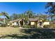 Beautiful one-story home with mature landscaping and palm trees at 19 Cambridge Trce, Ormond Beach, FL 32174