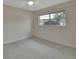 Bright bedroom with carpeted floor and large window at 2 Villa Villar Ct # 02, Deland, FL 32724