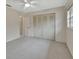 Bedroom with double door closet and carpet at 2 Villa Villar Ct # 02, Deland, FL 32724