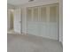 Simple bedroom with large closet and carpet at 2 Villa Villar Ct # 02, Deland, FL 32724