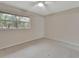 Spacious bedroom with ceiling fan and window at 2 Villa Villar Ct # 02, Deland, FL 32724