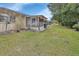 Side view of house, showing screened porch and yard at 2 Villa Villar Ct # 02, Deland, FL 32724
