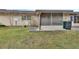 Rear exterior view showing screened porch and grassy yard at 2 Villa Villar Ct # 02, Deland, FL 32724