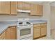 White kitchen appliances and light wood cabinets at 2 Villa Villar Ct # 02, Deland, FL 32724
