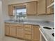 Kitchen with light wood cabinets and a double sink at 2 Villa Villar Ct # 02, Deland, FL 32724