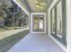 Covered back patio with French doors and ceiling fan at 204 Wellington Woods Ave, Deland, FL 32724