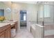 Spa-like bathroom with soaking tub, walk-in shower, and bedroom access at 204 Wellington Woods Ave, Deland, FL 32724