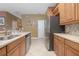 Modern kitchen with stainless steel appliances and light wood cabinets at 204 Wellington Woods Ave, Deland, FL 32724