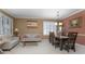 Light-filled living room with beige couch, wooden coffee table, and large windows at 204 Wellington Woods Ave, Deland, FL 32724