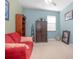Cozy office space with a red couch, built-in shelving, and window light at 204 Wellington Woods Ave, Deland, FL 32724