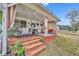Covered patio with seating area, steps, and string lights at 216 Hickory Ave, Orange City, FL 32763