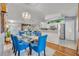Bright dining area with a glass table and blue chairs at 216 Hickory Ave, Orange City, FL 32763