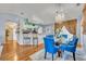 Elegant dining area with a glass table and blue chairs at 216 Hickory Ave, Orange City, FL 32763