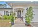 Inviting front porch with a bench and lush landscaping at 216 Hickory Ave, Orange City, FL 32763