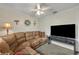 Spacious living room with sectional sofa and ceiling fan at 216 Hickory Ave, Orange City, FL 32763